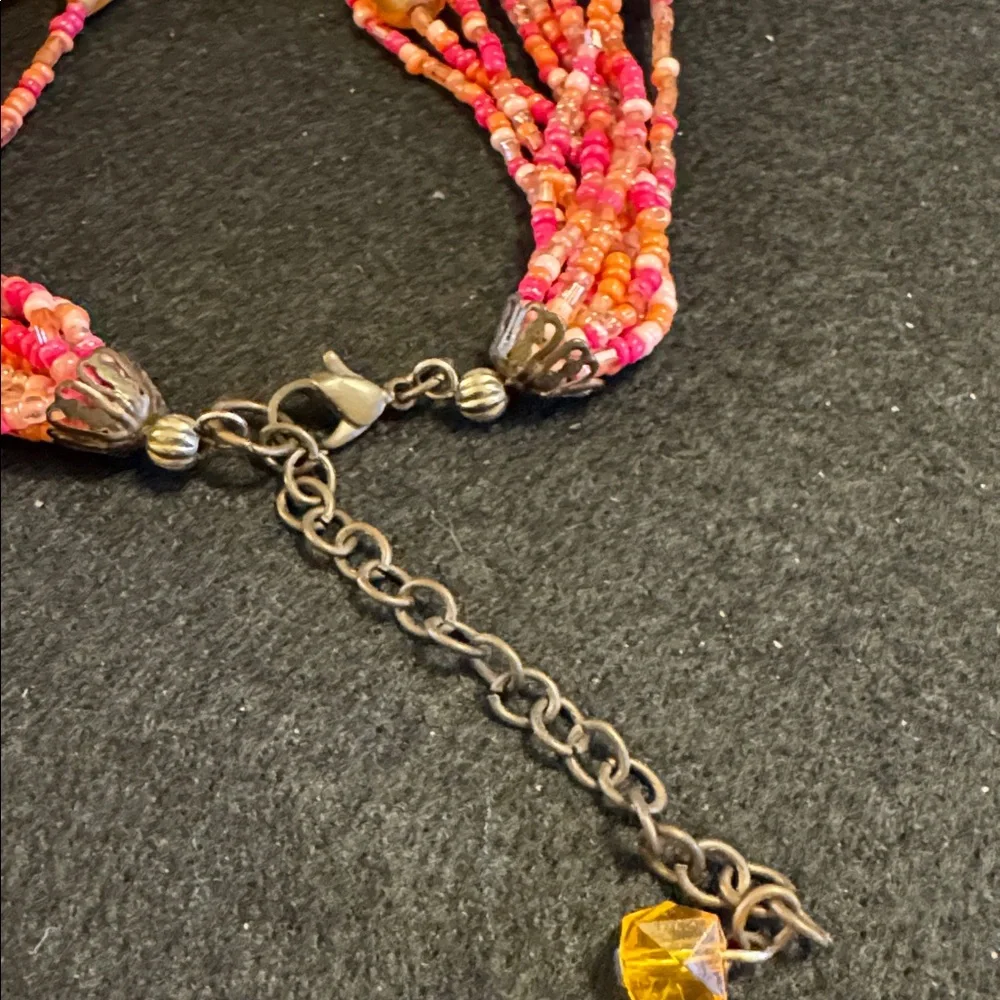 Multi strand torsade style necklace w/coral,pink and salmon colored seed beads